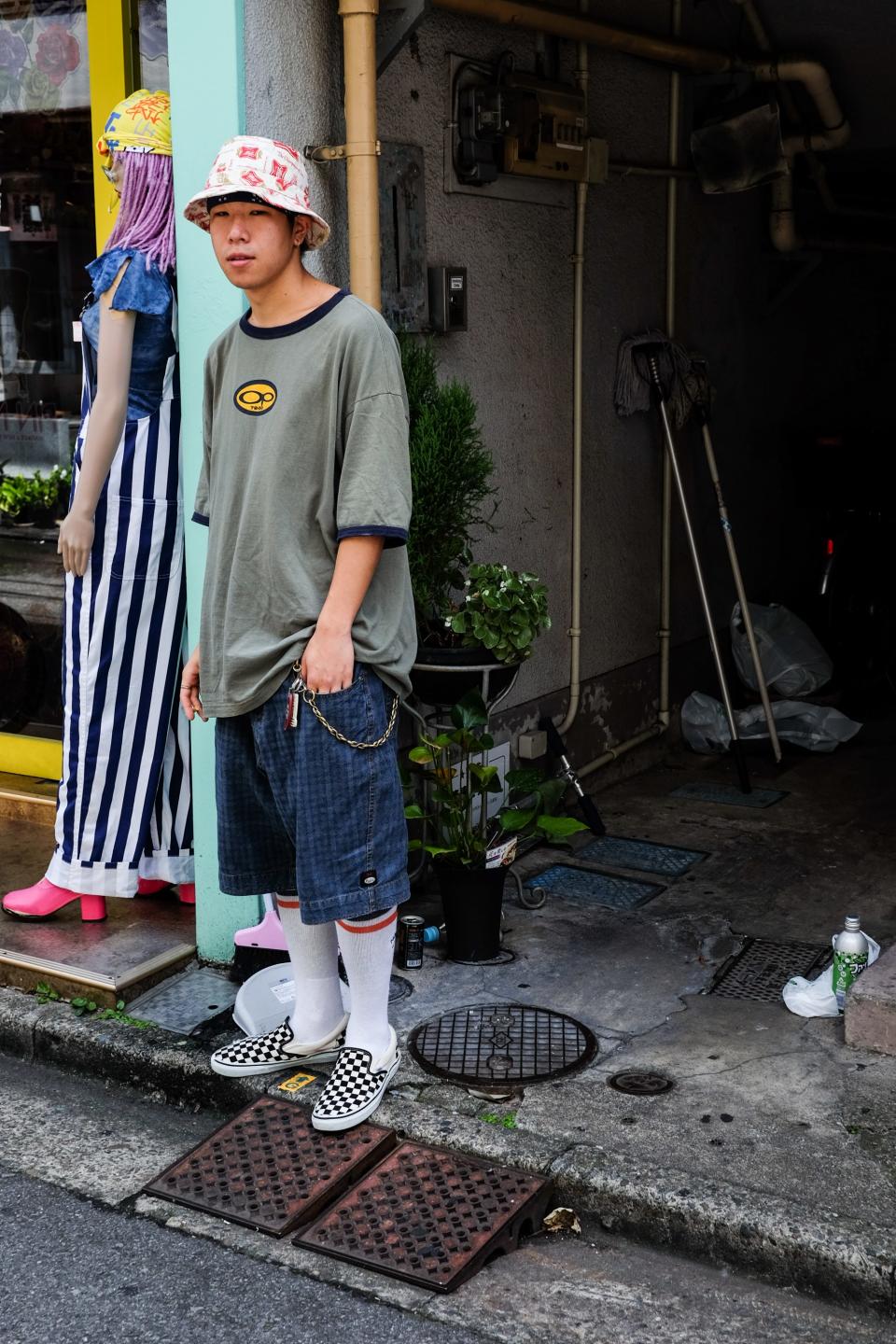 “The vintage Miller hat and OP tee! He probably works at a vintage store. This kid is so cool with the baggy shorts, the chain, the west coast socks with the Vans. But my favorite part is the bandana under the bucket. I love it.”