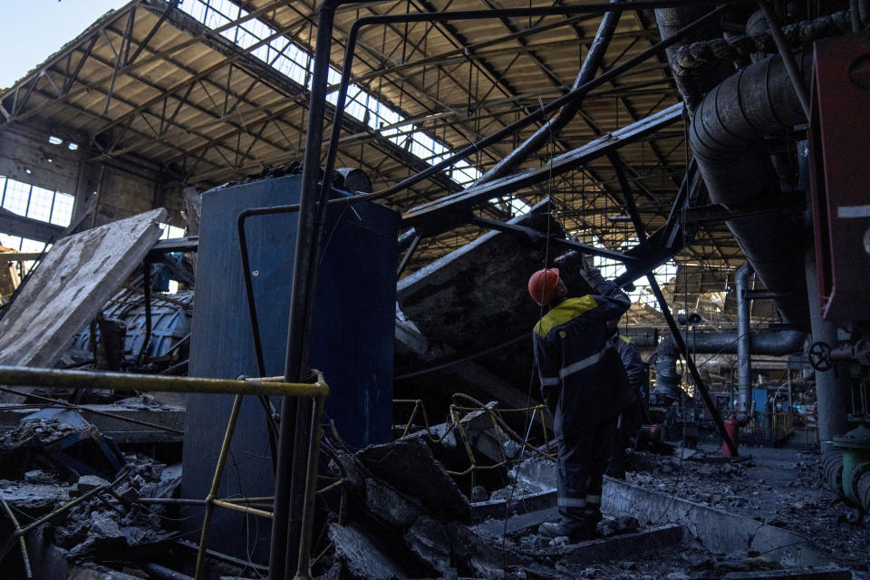 Workers walk among debris in a damaged DTEK thermal power plant after a Russian attack in Ukraine, Thursday, May 2, 2024. Ukrainian energy workers are struggling to repair the damage from intensifying airstrikes aimed at pulverizing Ukraine's energy grid, hobbling the economy and sapping the public's morale. (AP Photo/Francisco Seco)