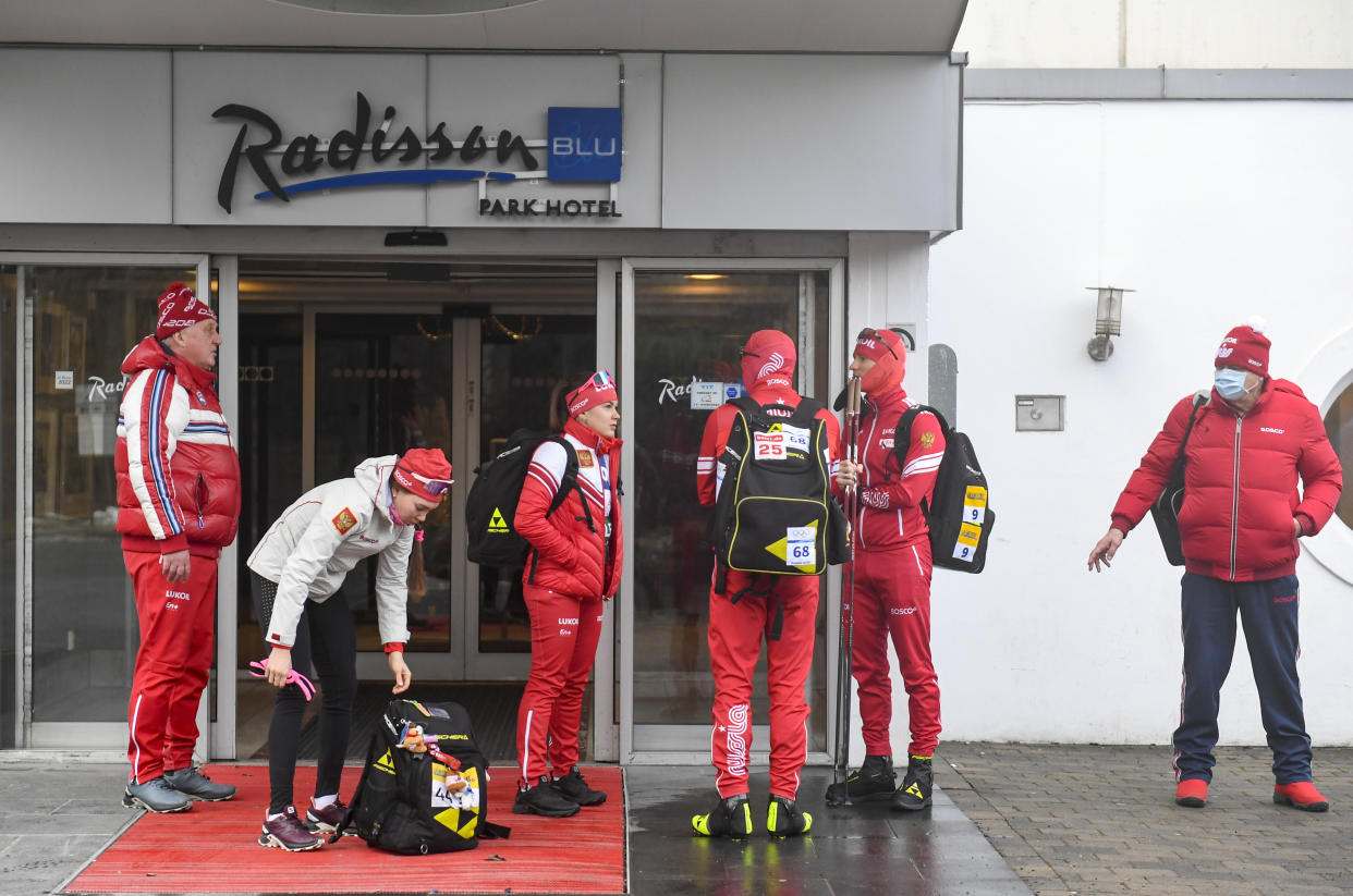 Members of the Russian cross-country ski national team stand outside the Radisson Blu Hotel at Fornebu, Oslo, Tuesday March 1, 2022. Norway challenged a decision by the International Ski Federation to allow Russians to keep competing, and said it would block them from upcoming rounds of the World Cup that Norway hosts this week. (Annika Byrde/NTB scanpix via AP)