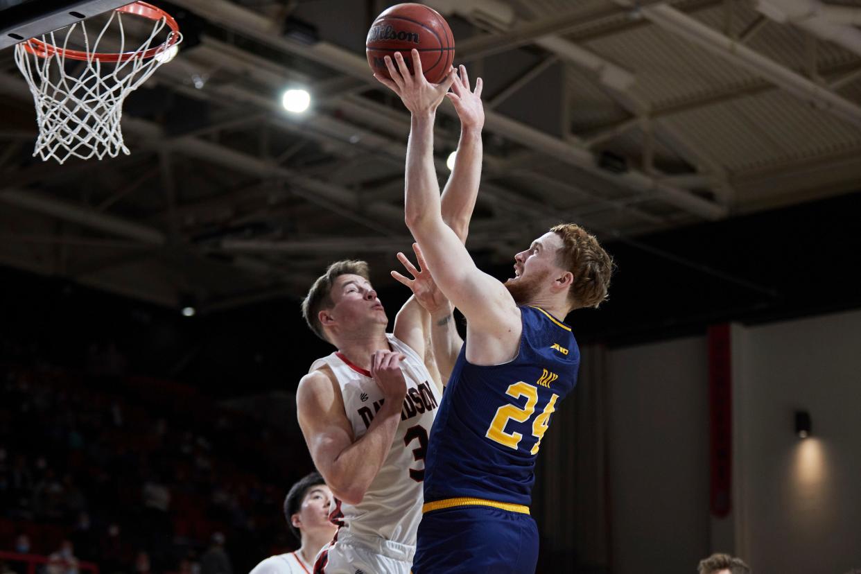 La Salle guard Christian Ray (24) shoots over Davidson forward Sam Mennenga (3) during the second half of an NCAA college basketball game on Sunday, Jan. 30, 2022, at Davidson.