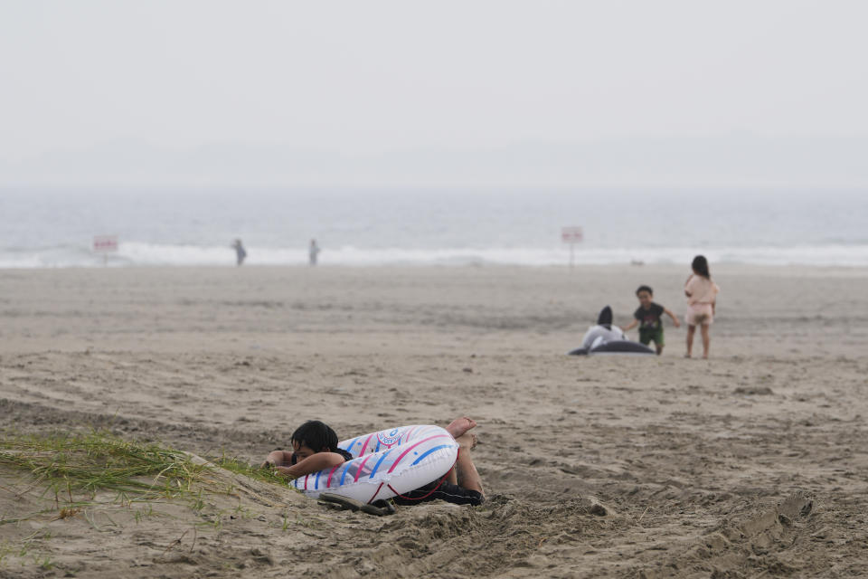 Children play at the Yotsukura beach in Iwaki, northeastern Japan, Saturday, July 15, 2023. (AP Photo/Hiro Komae)