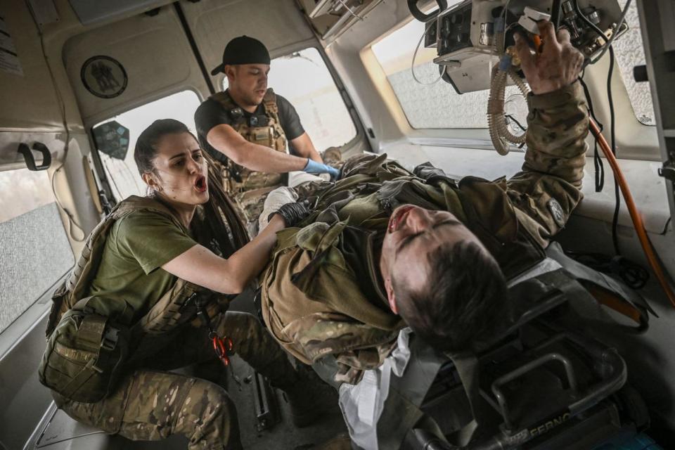 Ukrainian military paramedics evacuate a wounded serviceman from the front line near Bakhmut on March 23, 2023. (Aris Messinis/AFP via Getty Images)