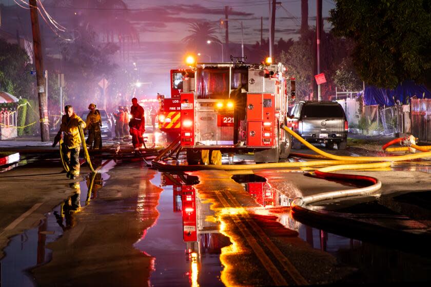 SOUTH LOS ANGELES, CA - NOVEMBER 28: Firefighters fight a massive fire at an apartment building in the framing stages of construction caused evacuations of nearby residents at 1585 E. Vernon St. on Tuesday, Nov. 28, 2023 in South Los Angeles, CA. (Irfan Khan / Los Angeles Times)