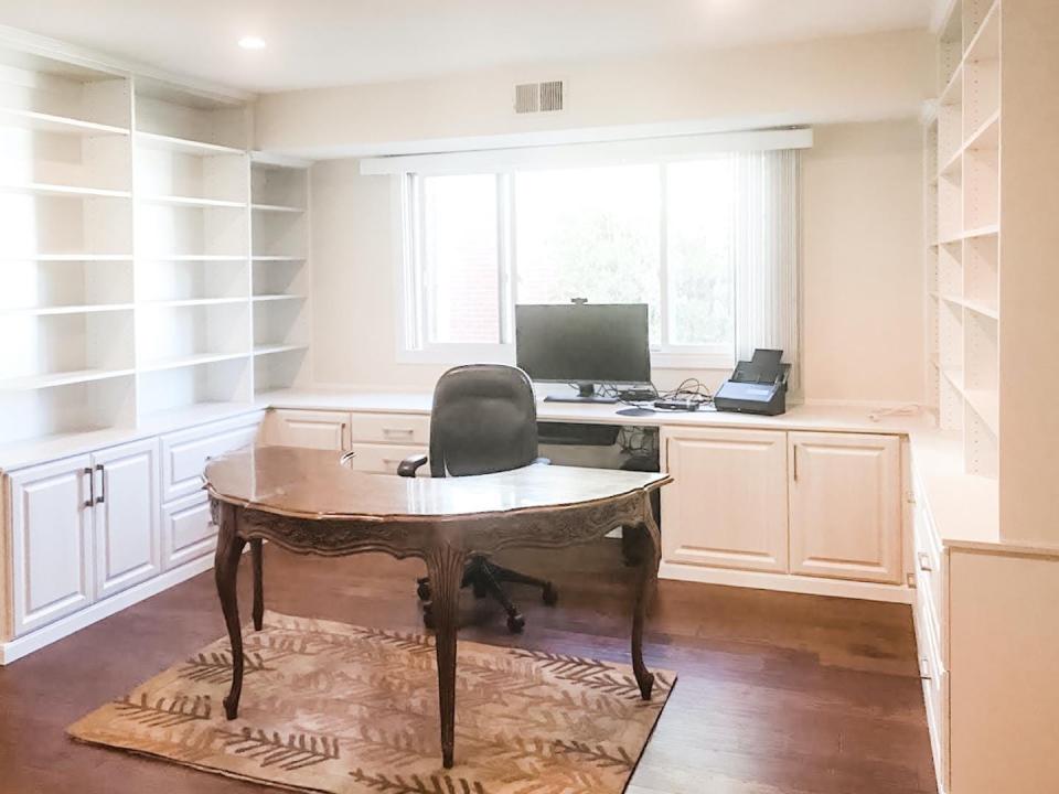 This Illinois home office features a curved writing desk surrounded by built-in cabinets, desk and shelving done by Pieces Into Place.