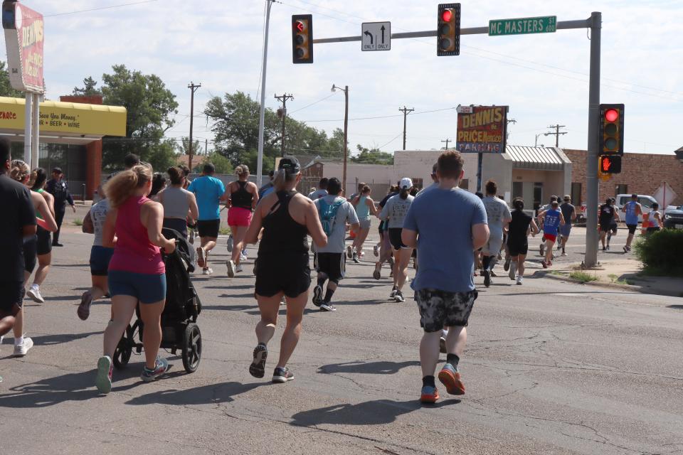 Participants run in the Fitness @ KT Black 5K Run, which was part of this year's Texas Route 66 Festival. The Saturday morning event's proceeds will benefit Hope Lives Here.