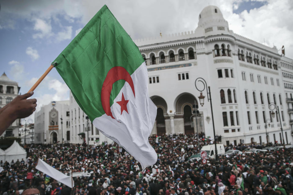 People chant slogans and wave flags during a demonstration in Algiers, Algeria, Wednesday, April 10, 2019. The Algerian senator Abdelkader Bensalah named to temporarily fill the office vacated by former President Abdelaziz Bouteflika said he would act quickly to arrange an "honest and transparent" election to usher in an "Algeria of the future." (AP Photo/Mosa'ab Elshamy)