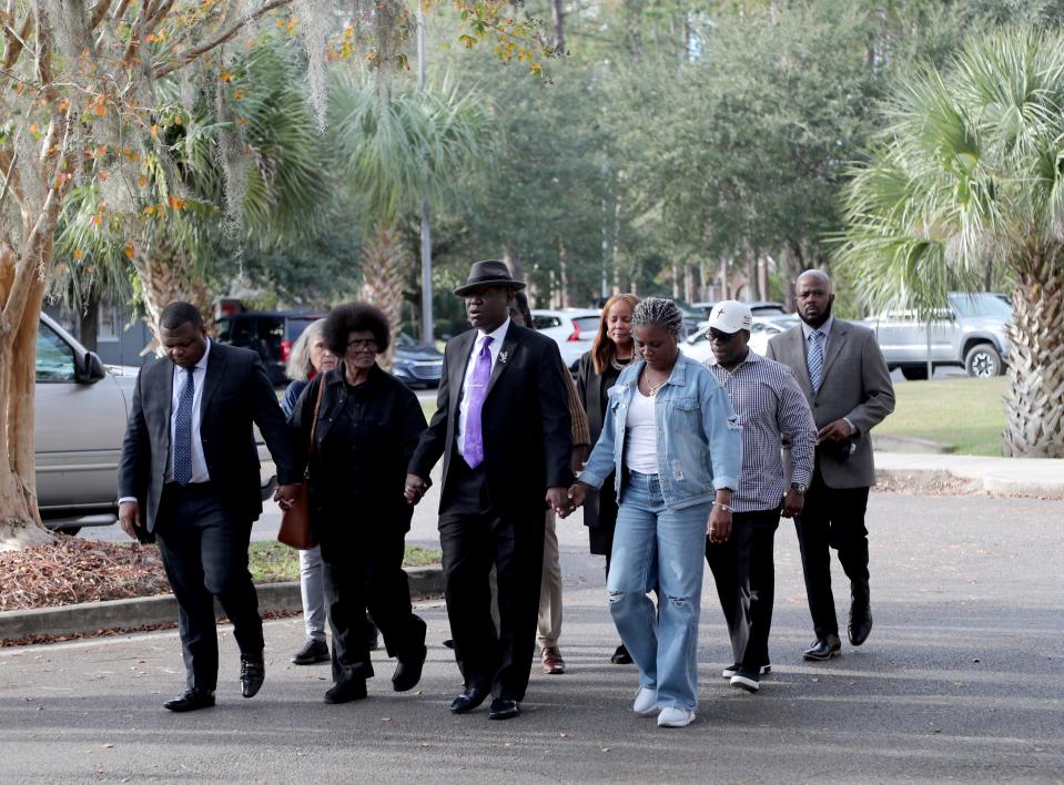 Attorney Harry Daniels, left, walks with Mary Cure, Attorney Ben Crump, and other members of the Cure family and legal team on Tuesday, December 5, 2023 before a press conference at the Camden County Courthouse in Woodbine, Georgia. Attorney Crump announced the filing of an intent to sue the Camden County deputy that fatally shot Leonard Cure during a traffic stop in October.