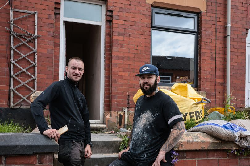 Builders Adam Wilby (L) and Andrew Burgess, who unearthed the 'ammunition shell'