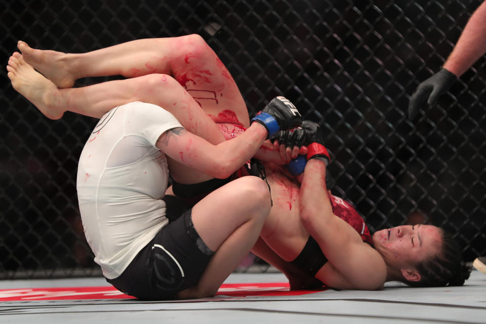 BEIJING, CHINA - NOVEMBER 24:  (R-L) Weili Zhang of China secures an arm bar submission against Jessica Aguilar in their women's strawweight bout during the UFC Fight Night event at Cadillac Arena on November 24, 2018 in Beijing, China.  (Photo by Emmanuel Wong/Getty Images)