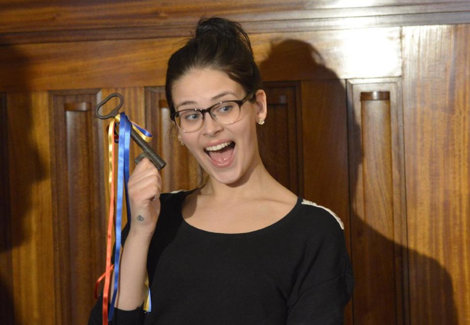 Finnish 19-year old girl Sara Maria Forsberg, right, poses with the key to her home town at the Pietarsaari City Hall on Tuesday March 18, 2014, in symbolic recognition of her new found fame. Supermarket cashier Firsberg has more than 9 million views on her language imitation YouTube video "What languages sound like to a foreigner", and now she hopes her celebrity status will open new career opportunities for her. (AP Photo / LEHTIKUVA, Tomi Hirvinen) FINLAND OUT - NO SALES