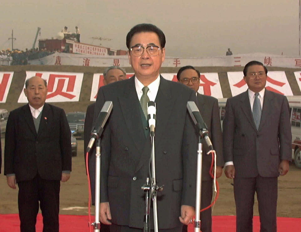 CORRECTS AGE TO 90, INSTEAD OF 91 - FILE - In this Nov. 8, 1997, file photo, released by China's Xinhua News Agency, then Chinese Premier Li Peng, center, gives the order to block one side of China's Yangtze River at Sandouping during a ceremony at the site of the Three Gorges Dam in China's Hubei province. Li Peng, a former hard-line Chinese premier best known for announcing martial law during the 1989 Tiananmen Square pro-democracy protests, has died. He was 90. (Xinhua via AP, File)