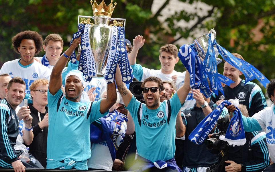 Chelsea's Didier Drogba and Cesc Fabregas celebrate with the Barclays Premier League trophy and Capital One Cup during the parade