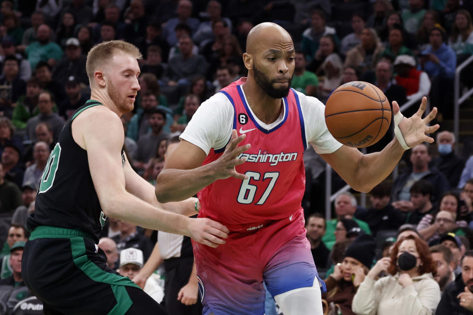 Washington Wizards forward Taj Gibson (67) grabs a loose ball next to Boston Celtics forward Sam Hauser (30) during the first half of an NBA basketball game Sunday, Nov. 27, 2022, in Boston. (AP Photo/Mary Schwalm)