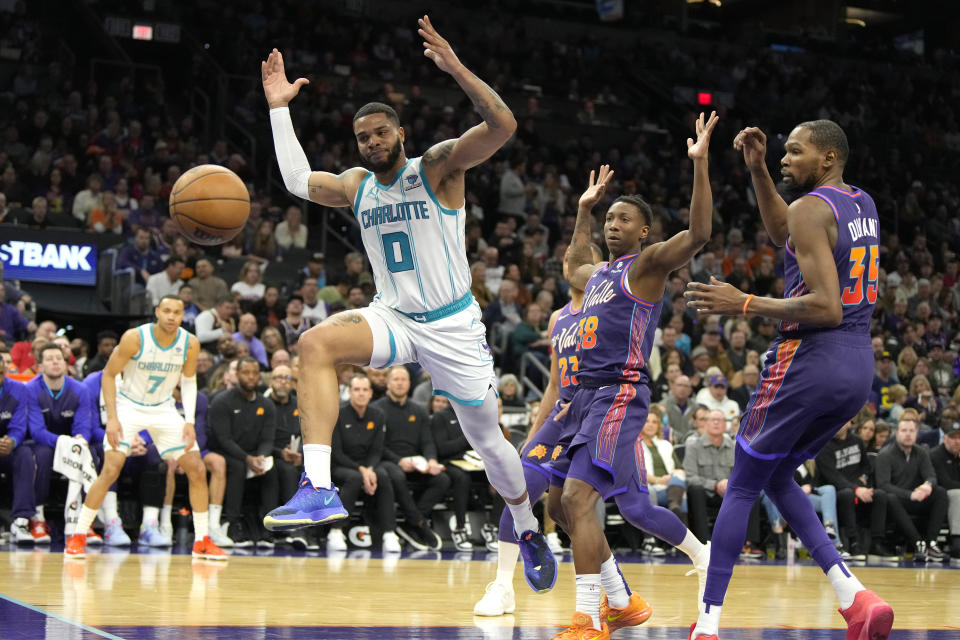 Charlotte Hornets forward Miles Bridges (0) runs after the loose ball in front of Phoenix Suns guard Eric Gordon (23), guard Saben Lee (38), and forward Kevin Durant during the first half of an NBA basketball game, Friday, Dec. 29 2023, in Phoenix. (AP Photo/Rick Scuteri)