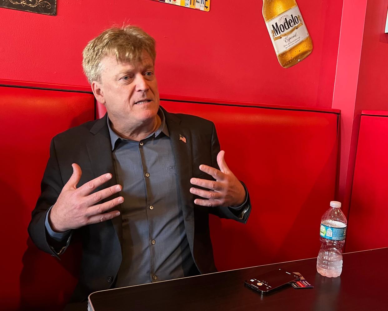 Former Overstock CEO Patrick Byrne speaks with a reporter after a press conference at a restaurant near the Conservative Political Action Conference. Byrne is one of the most prominent figures pushing unfounded claims about voting fraud in the 2020 election.