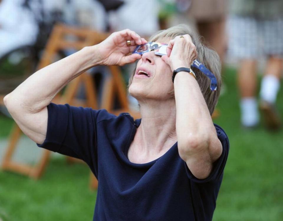 Pam Ishler looks at the eclipse Monday, Aug. 21, 2017 at The Arboretum at Penn State.