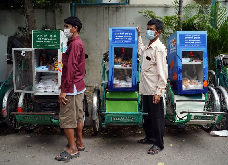 Cambodian cyclo-drivers pedal mobile food banks to deliver aid