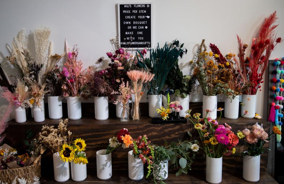 Miriam "Mili" Cordero owns Mili's Flowers and Gifts on Tuesday, Oct. 4, 2022, at Crosstown Concourse in Memphis. Patrons of the store can create their own flower bouquets as well as shop for various Mexican-made items. 