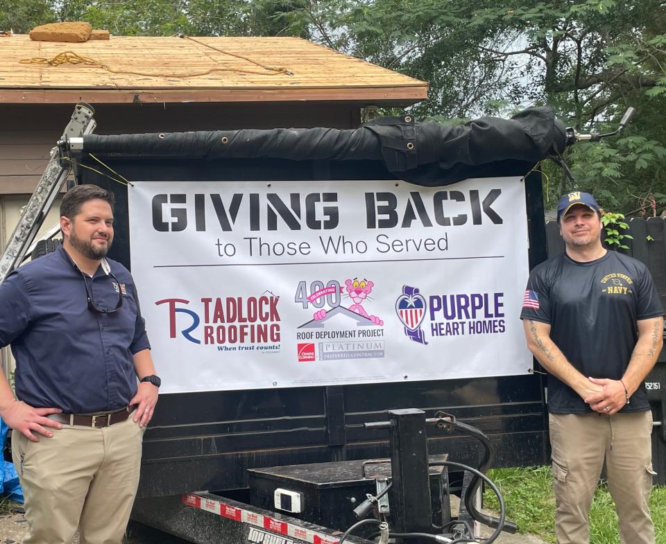 Thomas Catalano (left)  from Tadlock Roofing is pictured with Josh Kish (right) in front of his home as a new roof is installed with the help of Tadlock Roofing, Purple Heart Homes and Owen Corning.