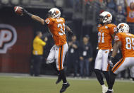 VANCOUVER, CANADA - NOVEMBER 27: Andrew Harris #33, Geroy Simon #81 and Shawn Gore #85 of the BC Lions celebrate the opening touchdown against the Winnipeg Blue Bombers during the CFL 99th Grey Cup November 27, 2011 at BC Place in Vancouver, British Columbia, Canada. (Photo by Jeff Vinnick/Getty Images)