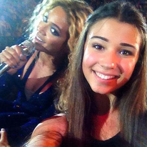 Selfie of girl with Beyoncé in the background