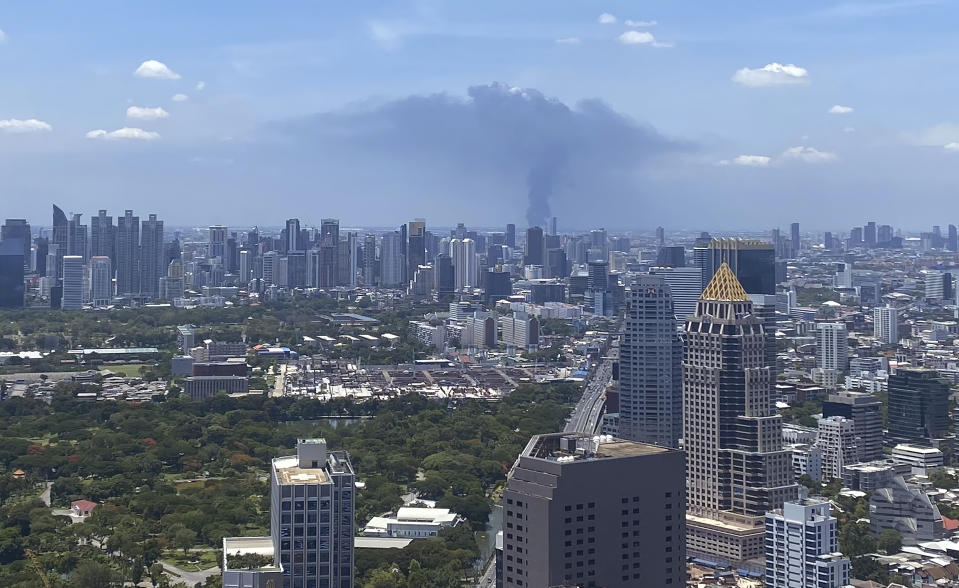 In a view from downtown Bangkok, giant plumes of smoke can be seen rising from the Samut Prakan province area in central Thailand, Monday, July 5, 2021. A massive explosion at a factory on the outskirts of Bangkok has shaken an airport terminal serving Thailand’s capital, damaged homes in the surrounding neighborhood, and prompted the evacuation of a wide area over fears of poisonous fumes from burning chemicals and the possibility of additional denotations. (Tina Liu via AP)