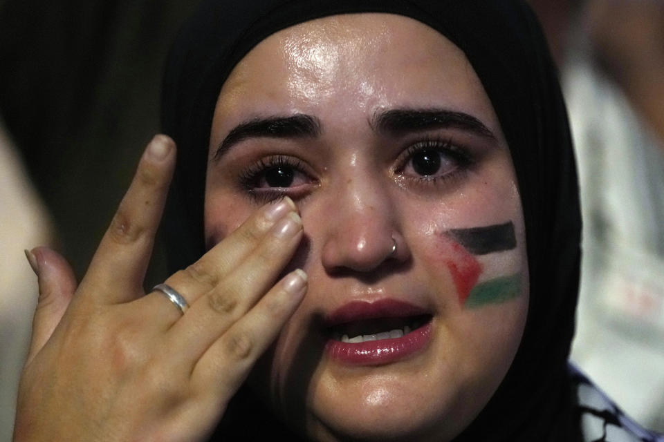 Una mujer con una bandera palestina pintada en el rostro llora durante una protesta contra los ataques aéreos israelíes en Gaza, en Madrid, España, el lunes 9 de octubre de 2023. (AP Foto/Paul White, Archivo)