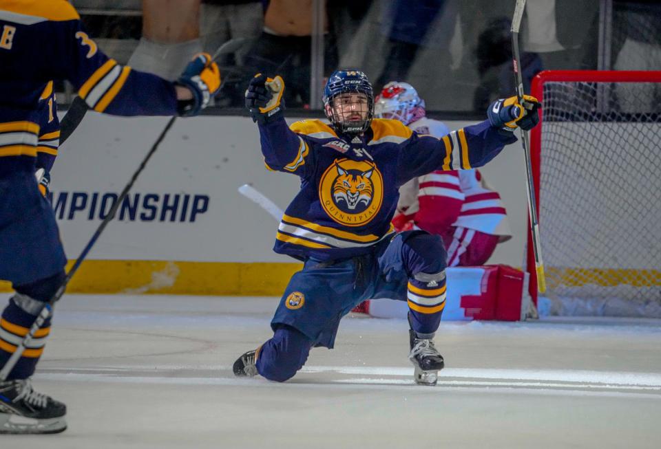 Quinnipiac's Victor Czerneckianair celebrates the game-winning goal in OT to beat Wisconsin Friday night at the AMP.