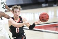 Texas Tech's Mac McClung (0) passes the ball during the second half of an NCAA college basketball game against Baylor in Lubbock, Texas, Saturday, Jan. 16, 2021. (AP Photo/Justin Rex)