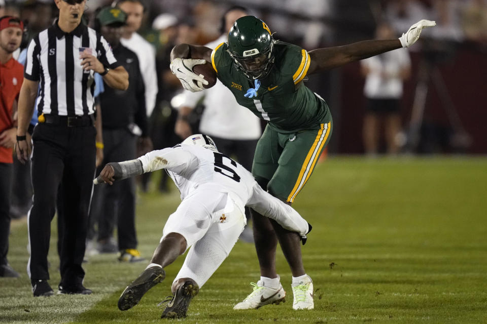 Baylor tight end Michael Trigg (1) runs around Iowa State defensive back Myles Purchase (5) after catching a pass during the first half of an NCAA college football game, Saturday, Oct. 5, 2024, in Ames, Iowa. (AP Photo/Charlie Neibergall)