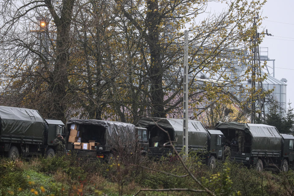 Polish army soldiers unload equipment from their trucks, near the place where a missile struck killing two people in a farmland at the Polish village of Przewodow, near the border with Ukraine, Wednesday, Nov. 16, 2022. (AP Photo/Evgeniy Maloletka)