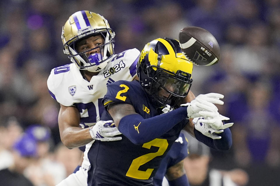 Michigan defensive back Will Johnson intercepts a pass intended for Washington running back Tybo Rogers during the second half of the national championship NCAA College Football Playoff game Monday, Jan. 8, 2024, in Houston. (AP Photo/Eric Gay)