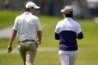 Rory McIlroy, of Northern Ireland, left, walks with U.S. Women's Open golf winner Yuka Saso, of the Philippines, during a practice round of the U.S. Open Golf Championship, Tuesday, June 15, 2021, at Torrey Pines Golf Course in San Diego. (AP Photo/Gregory Bull)