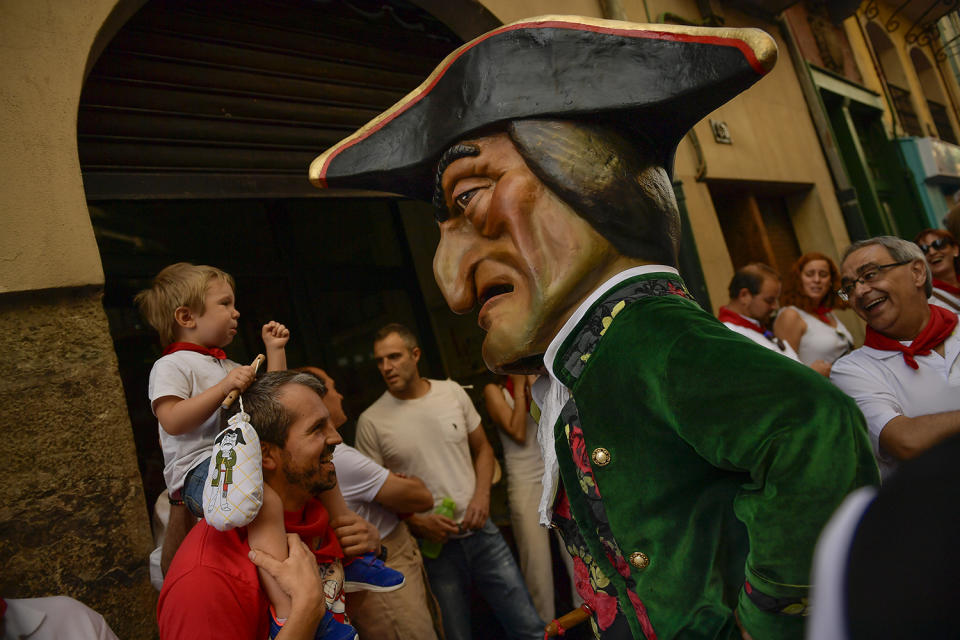 <p>A boy cries next to a member of the San Fermin Comparsa Parade, during a religious procession at the San Fermin Festival, in Pamplona, northern Spain, July 7, 2017. (Alvaro Barrientos/AP) </p>