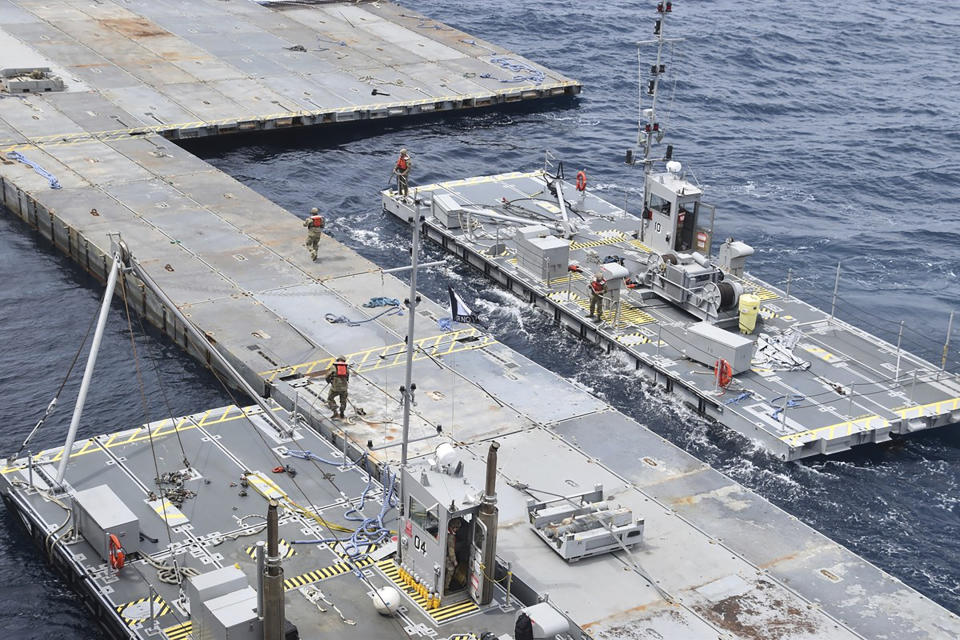 This undated photo released early Tuesday, April 30, 2024, by the U.S. military's Central Command shows construction off a floating pier in the Mediterranean Sea off the Gaza Strip. A U.S. Navy ship involved in the American-led effort to bring more aid into the besieged Gaza Strip is off shore from the enclave, slowly building out a floating platform for the operation, satellite photos analyzed Monday, April 29, 2024, by The Associated Press show. (U.S. military's Central Command via AP)