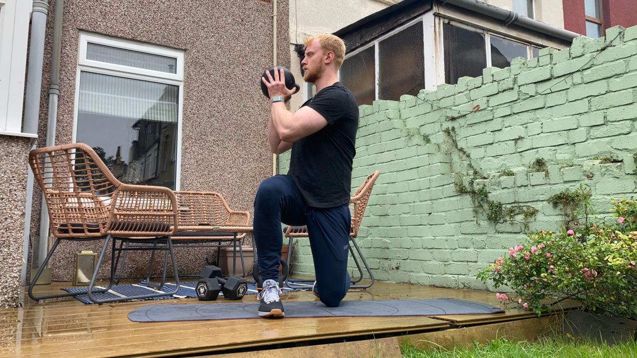  Fit&Well fitness writer Harry Bullmore performing a half-kneeling kettlebell rotation. 