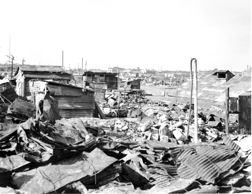 FILE - In this Sept. 7, 1945, file photo, makeshift housing built from galvanized iron roofing of burned buildings stand amid destruction and rubble in Tokyo. U.S. bombings of more than 60 Japanese cities from January 1944 to August 1945 killed an estimated 333,000 people, including the victims of the Hiroshima and Nagasaki atomic bombings. (AP Photo/Frank Filan, File)