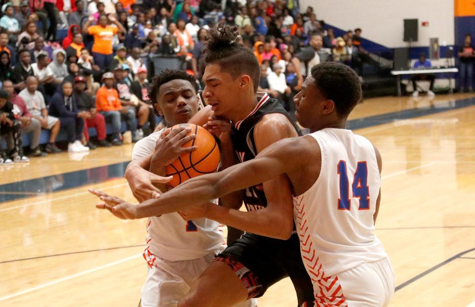Johnson's Kadin Davis and Favion Kirkwood attempt to trap Sandy Creek's Micah Smith during the Class 3A quarterfinals on Wednesday March 1, 2023.