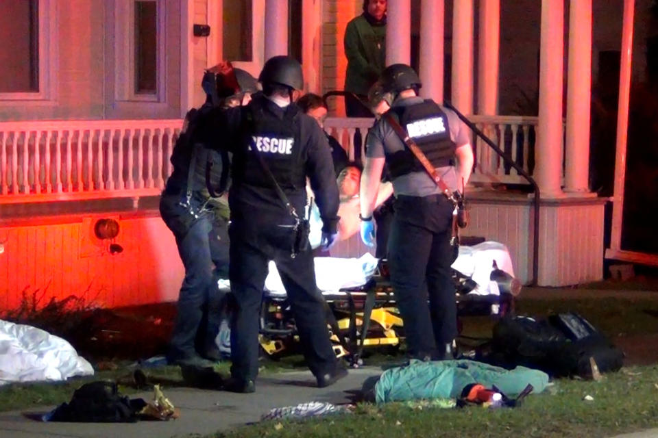 First responders lift one of the shooting victims onto a gurney.