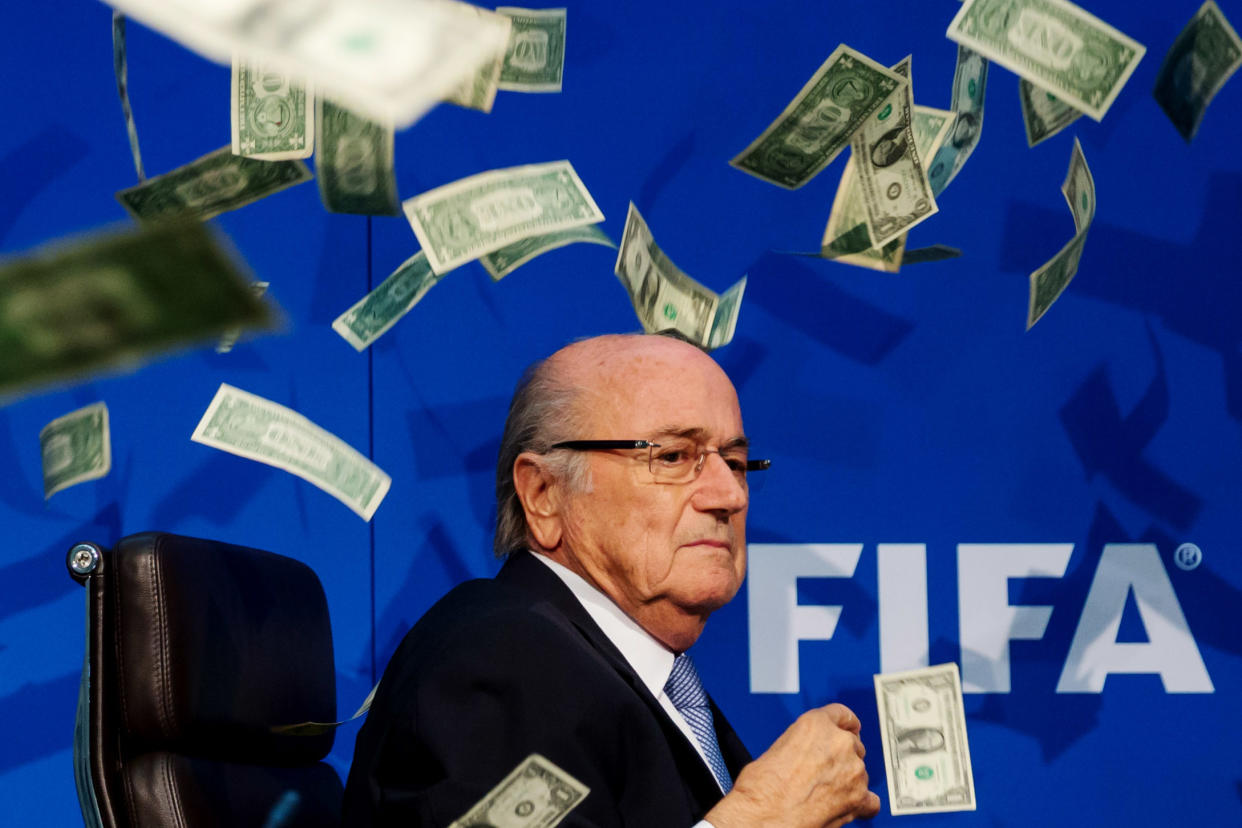 Sepp Blatter was showered in dollar bills during a news conference. (Getty)