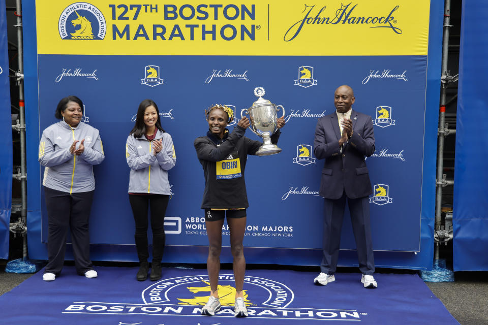 Hellen Obiri of Kenya holds up the trophy after winning the women's division of the 127th Boston Marathon Monday, April 17, 2023, in Boston. (AP Photo/Winslow Townson)