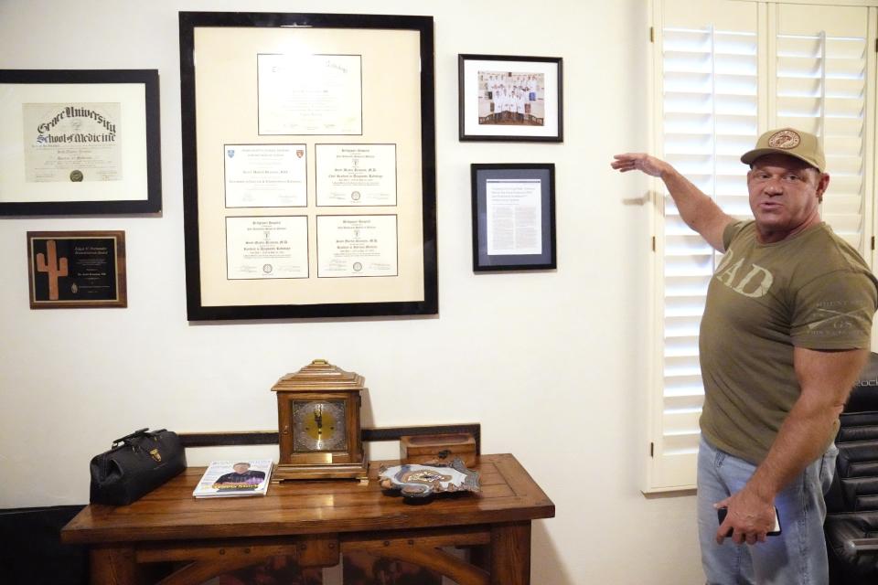 Dr. Scott Brannan answers questions about his medical certificates and degrees hanging inside his Scottsdale home on Sept. 21, 2022.