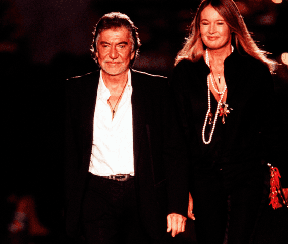 <p>Giovanni Giannoni/WWD/Penske Media via Getty Images</p> Designer Roberto Cavalli on the runway at show finale with wife Eva Duringer Cavalli. (Photo by Giovanni Giannoni/WWD/Penske Media via Getty Images)