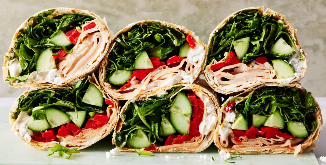 tortilla wrap with turkey, spinach, cucumbers, and red peppers