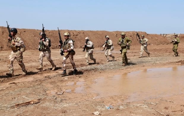 Coalition forces train Iraqi soldiers during a military exercise at Camp Taji, north of Baghdad, Iraq, Monday, March 20, 2017. (Hadi Mizban/Associated Press - image credit)