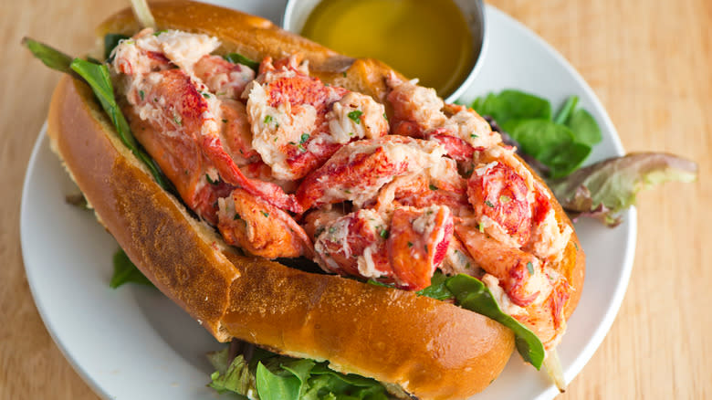 Lobster roll on a plate with salad