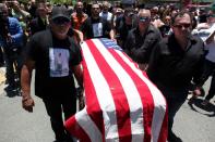 <p>Family and friends carry the coffin of Angel Candelario, one of the victims of the shooting at the Pulse night club in Orlando, covered with a American flag during his funeral at his hometown of Guanica, Puerto Rico, June 18, 2016. (Reuters/Alvin Baez) </p>