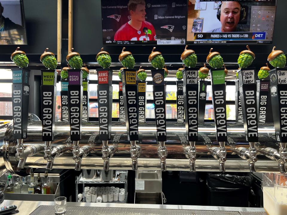 Taps with Big Grove beers sit behind the bar at Big Grove Brewery in Des Moines.