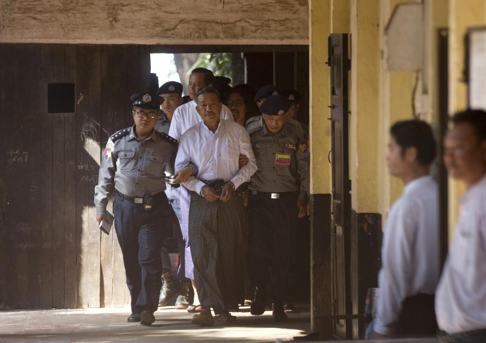 Kyi Lin, center, the gunman who shot a prominent Muslim lawyer who was a close adviser of Myanmar leader Aung San Suu Kyi, is escorted by police at Yangon Northern District Court in Yangon, Myanmar, Friday, Feb. 15, 2019. The court found Kyi Lin guilty of premeditated murder and illegal weapons possession and sentenced to death for the Jan. 29, 2017 shooting of lawyer Ko Ni in broad daylight at Yangon airport. (AP Photo/Thein Zaw)