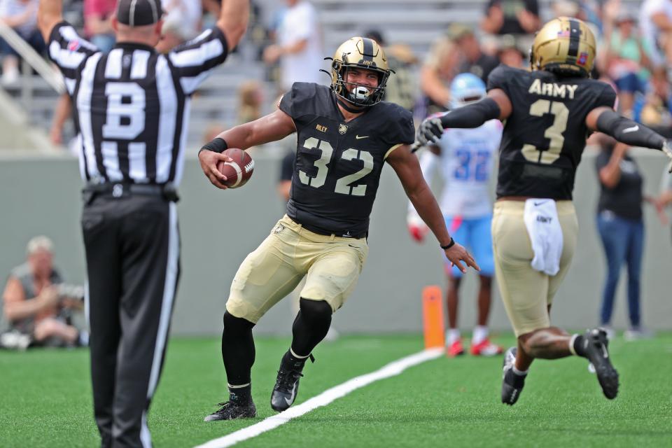 Army running back Tyson Riley (32) celebrates his touchdown reception against Delaware State during the first half at Michie Stadium.